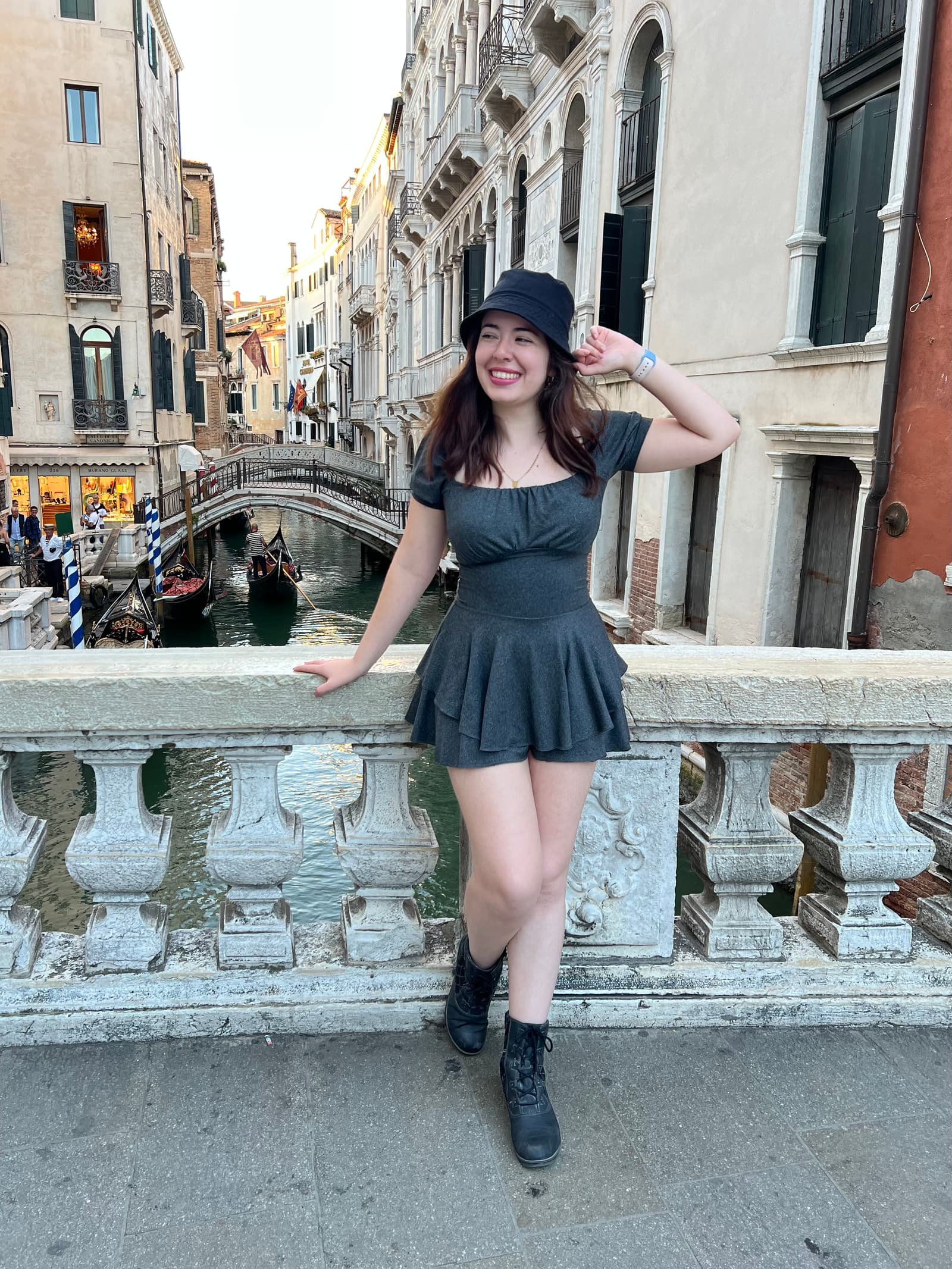 Valeria sonriendo en un puente de Venecia con un canal y góndolas de fondo